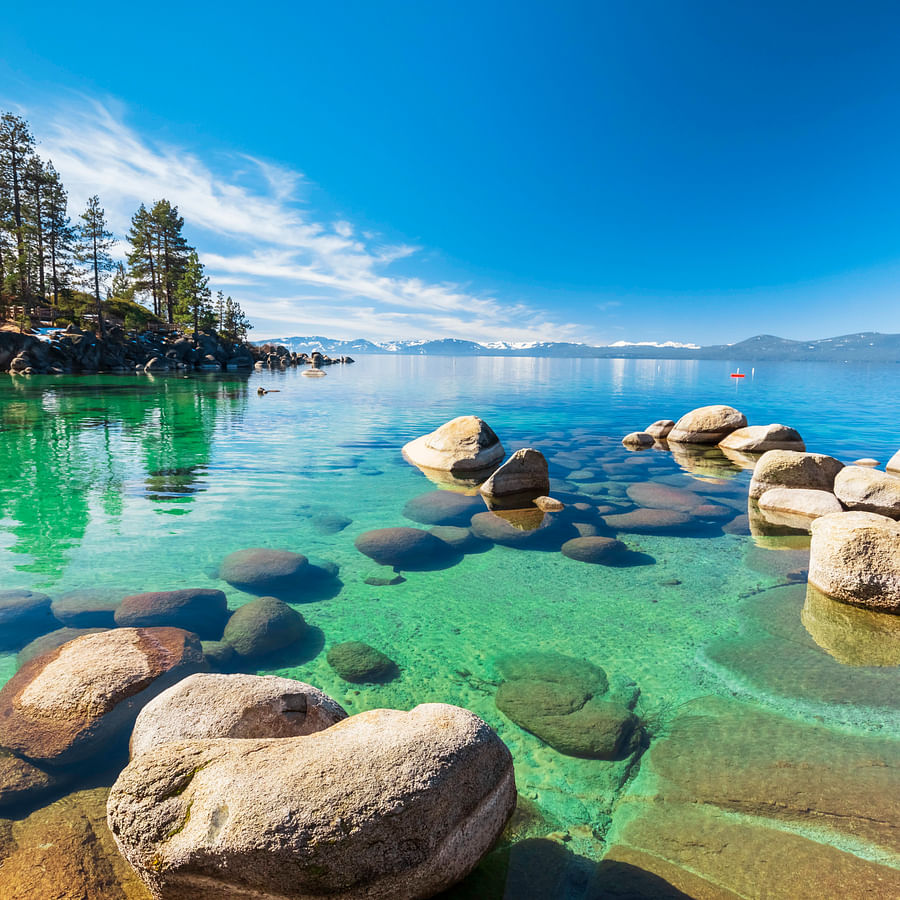 Serene hidden beach at Lake Tahoe with a scenic mountain backdrop