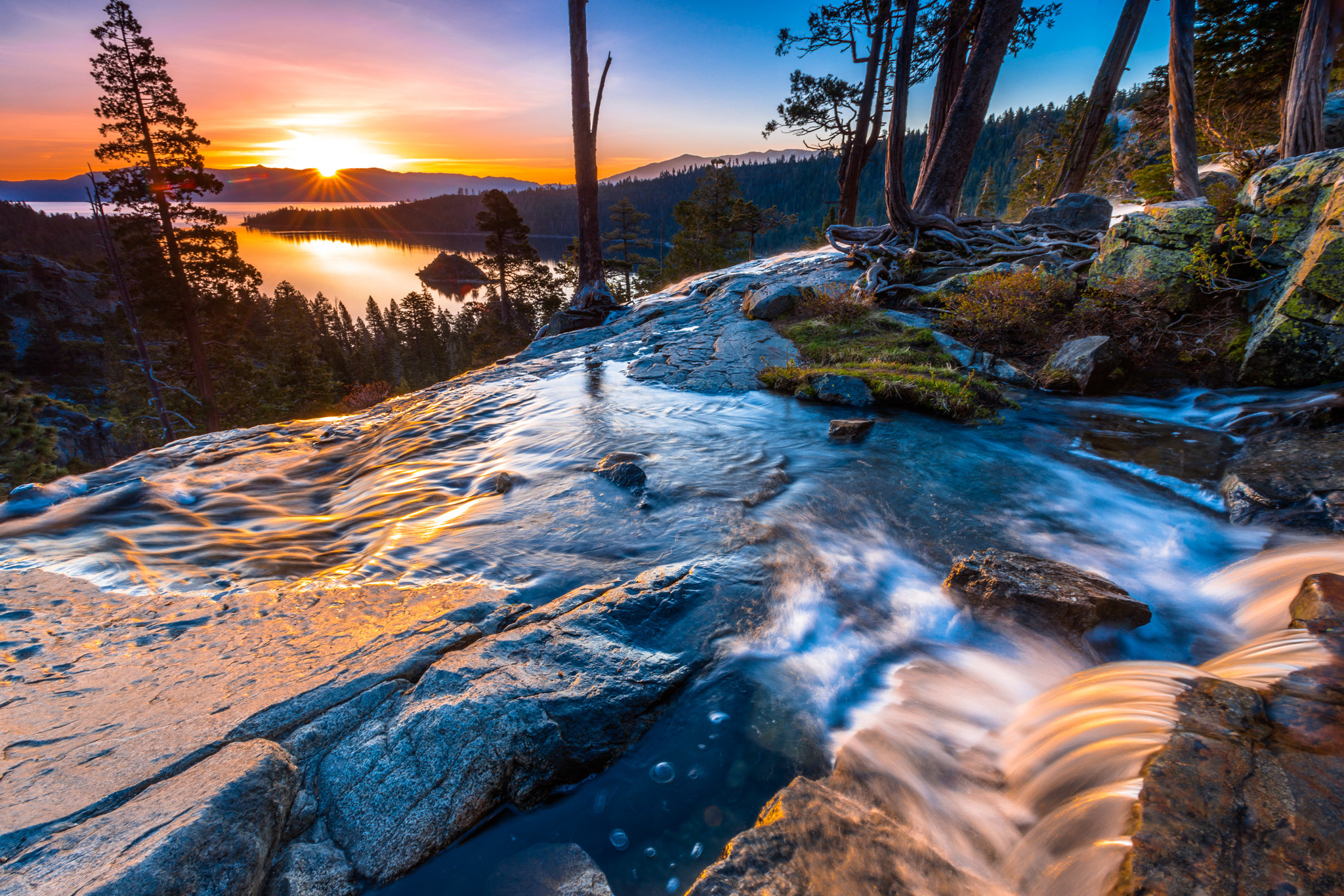 Sunset over Lake Tahoe with clear blue waters reflecting the sky