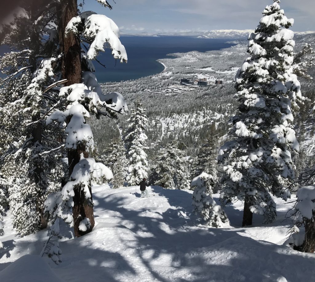 Skiers descending on the snow-covered mountains of Lake Tahoe